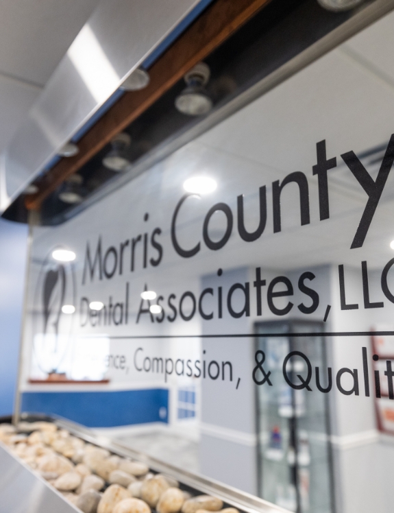 Morris County Dental Associates logo on glass window in Succasunna dental office