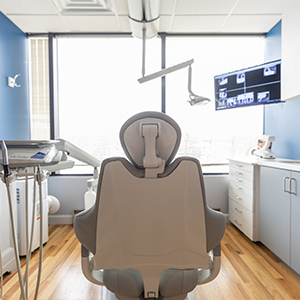 Gray dental treatment chair viewed from behind