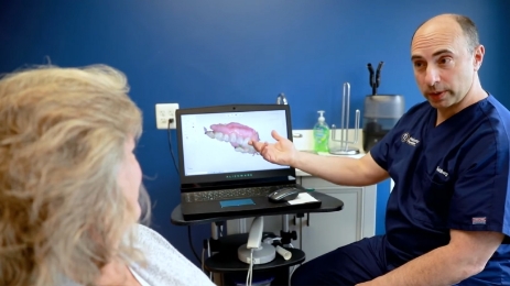 Succasunna dentist showing a patient a laptop with digital impressions of their teeth
