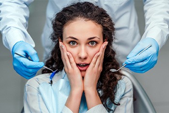 Woman afraid in the dental chair