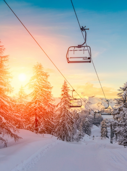 Ski lift above a mountain at sunset