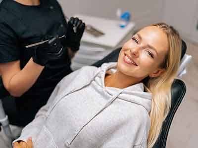 Patient reclined in treatment chair smiling