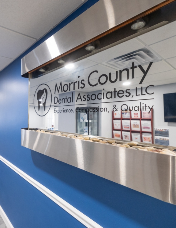 Morris County Dental Associates logo on glass window in Succasunna dental office