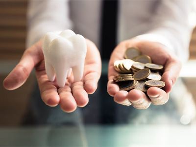 Tooth balanced with a pile of coins