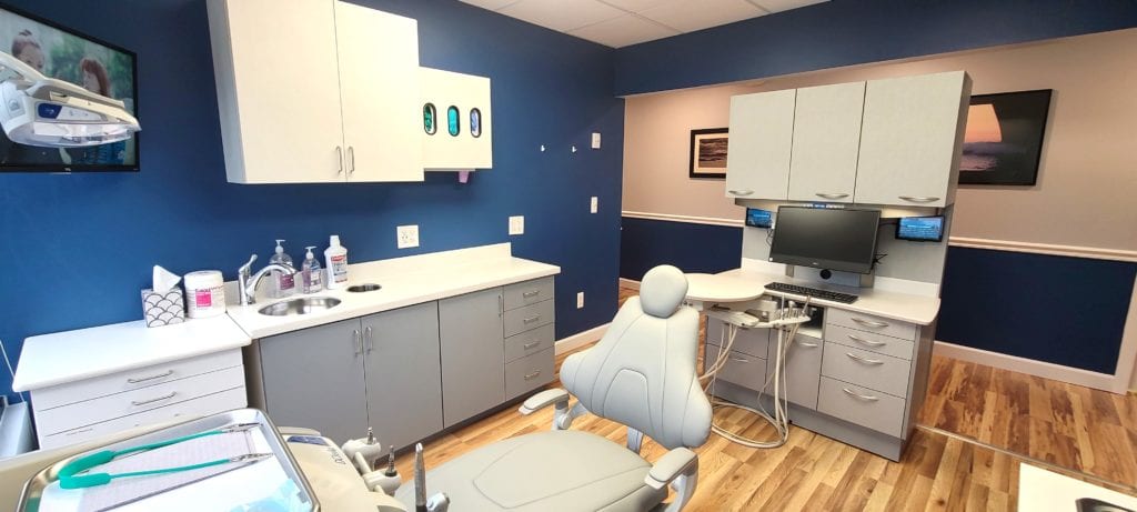 Dental treatment room with dark blue walls